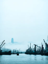 Boats in sea against clear sky