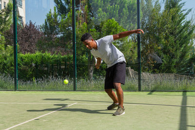 Black african american sportsman playing paddle tennis