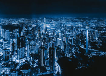 High angle view of illuminated buildings in city at night