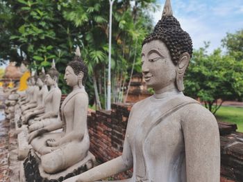 Statue of buddha against trees