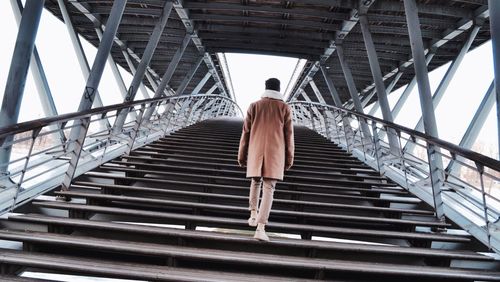 Rear view of woman walking on steps