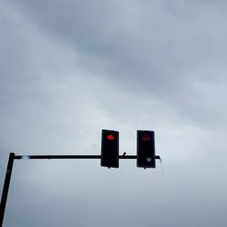 Low angle view of traffic lights against sky