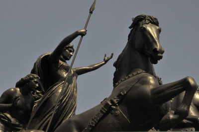 Low angle view of statue against sky