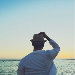 Man at sea against clear sky