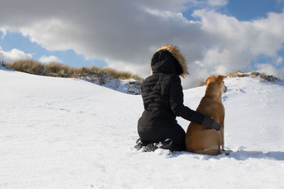 Rear view of man on snow covered field