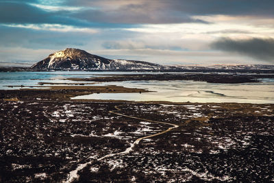 Scenic view of snow-covered volcano against sky during winter