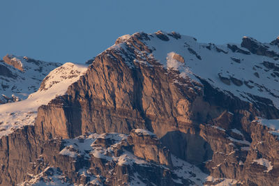 Scenic view of snowcapped mountains against clear sky