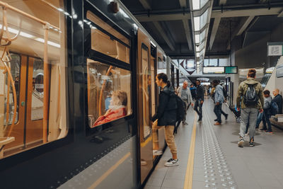 People on train at railroad station platform