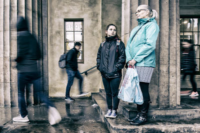 Men walking on sidewalk in city