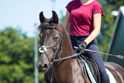 Midsection of jockey riding on horse