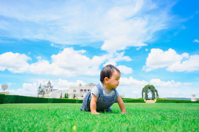 Boy on field against sky