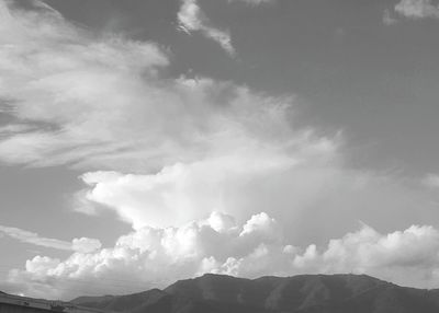 Scenic view of mountains against cloudy sky