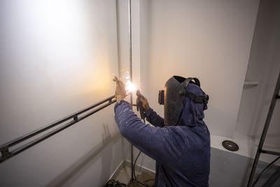 Man holding mobile phone at home