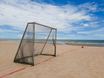 Lifeguard hut on beach against sky