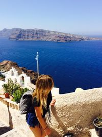Young woman looking at sea in oia