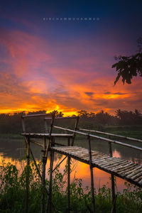 Scenic view of lake against orange sky