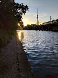 River passing through city at sunset