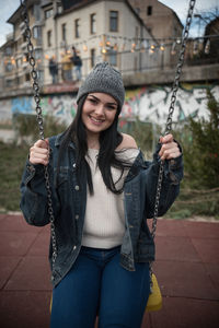 Young woman sitting on swing