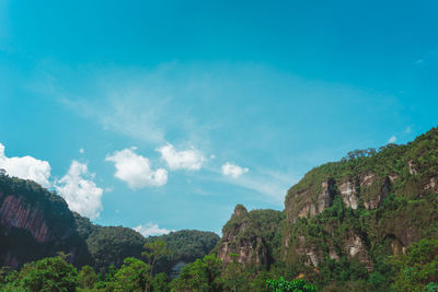 Scenic view of mountains against blue sky