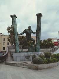 Statue of building against cloudy sky