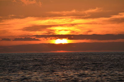 Scenic view of sea against orange sky