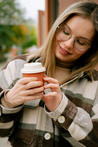 Young woman drinking coffee cup