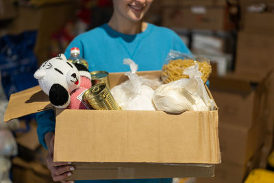 Volunteer girl preparing donation boxes for people.