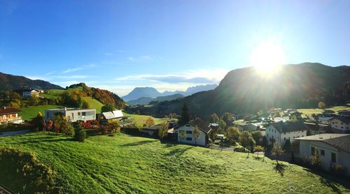 Scenic view of village by houses against sky