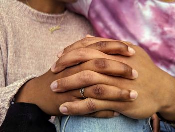 Close-up of woman hand on purple