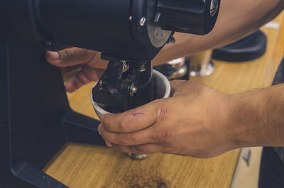 Hands on coffee grinder