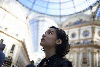 Close-up of woman looking away while standing in galleria vittorio emanuele ii