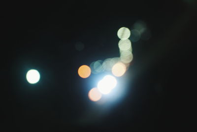 Low angle view of illuminated lights at night