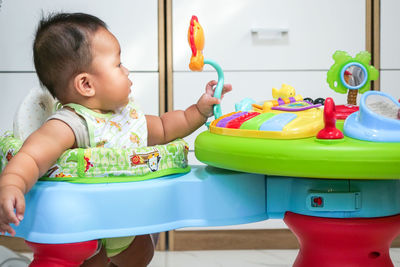 Cute girl playing with toy on table