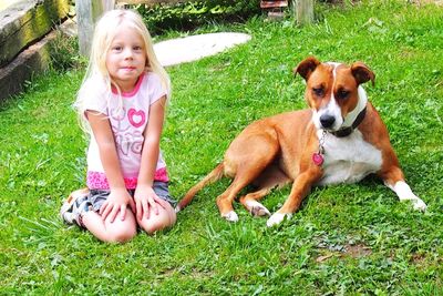 Portrait of cute girl playing with dog