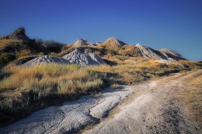 Scenic view of land against clear blue sky