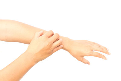 Close-up of hands over white background