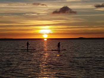 Scenic view of calm sea at sunset