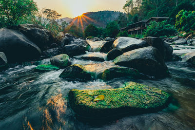 Scenic view of river flowing through rocks