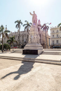 Statue against sky in city