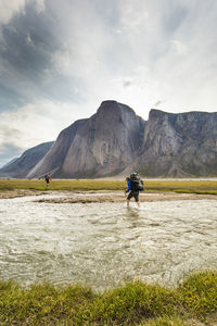 Climbers cross rivers and arctic tundra to reach illusive mountains.