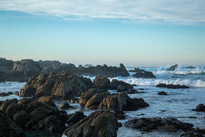 Rocks on beach against sky