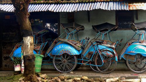 Tricycle parked by house