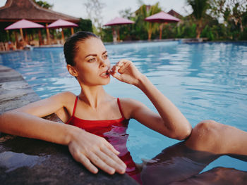 Young woman relaxing in swimming pool