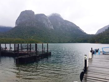 Pier on lake against mountain range