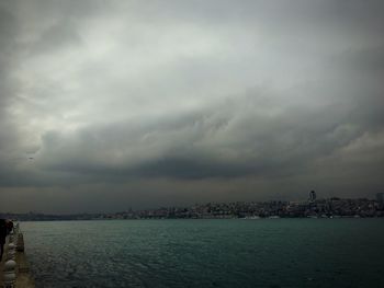 View of cityscape against cloudy sky