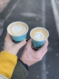 Midsection of person holding coffee cup