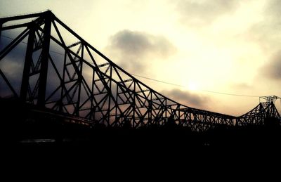 Low angle view of bridge against sky at sunset