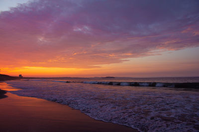 Scenic view of beach against sky during sunset