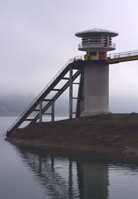 View of bridge over sea against cloudy sky