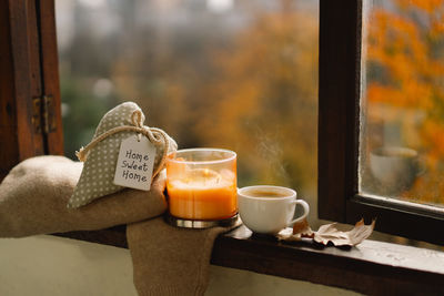 Sweater, candle, hot coffee and autumn decor. autumn home decor